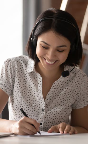 virtual assistant smiling while taking down notes